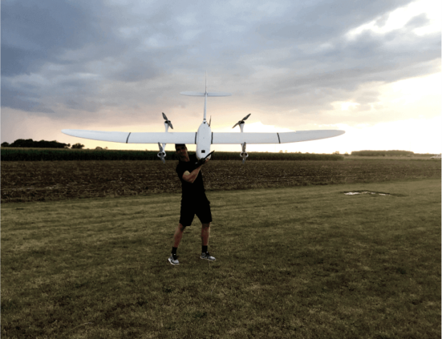 drone mapping man holding an unmanned aerial vehicle before take-off